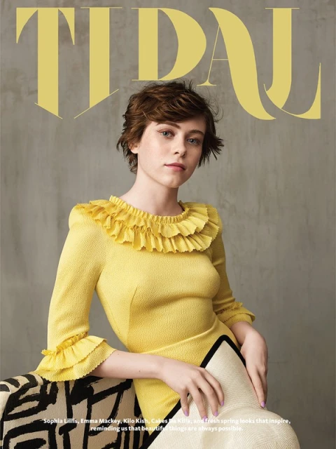 Portrait of Sophia Lillis on a magazine cover, wearing a yellow dress with ruffles, set against a neutral background with prominent yellow text.