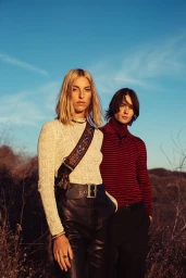 Two models standing outdoors against a clear blue sky, styled by Soaree Cohen in Los Angeles.