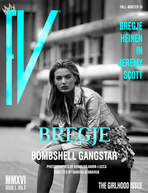 Magazine cover featuring a blonde model, Bregje Heinen, in a metallic jacket and sequined skirt, seated against an urban backdrop.