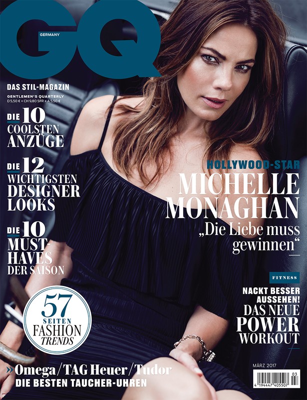 Michelle Monaghan graces the cover of GQ Germany, seated in a car wearing a chic black dress against a backdrop of magazine text.