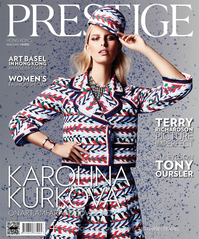 Fashion magazine cover featuring a posing blonde woman wearing a patterned skirt and jacket with matching hat against a speckled background.