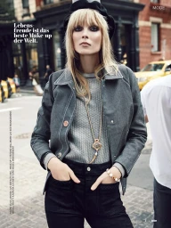 Model with blonde bangs wearing a black beret, grey jacket, and dark trousers on a city street with text overlays.