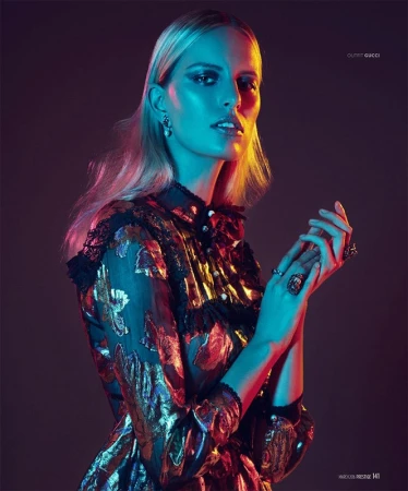 Portrait of a blonde woman in a metallic patterned dress under dramatic blue and red studio lighting