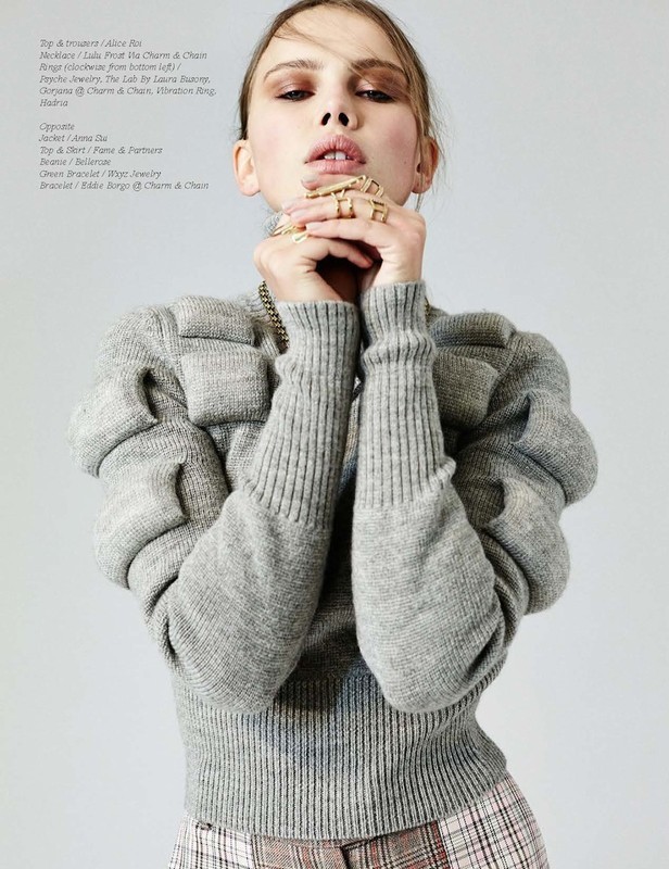 Portrait of a woman wearing a grey textured sweater with hands held to her face, featuring make-up by Stephanie Peterson.