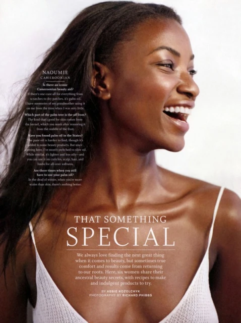 Smiling African-American woman in a beauty advertisement, showcasing skincare or cosmetic product. Close-up, indoor studio lighting.