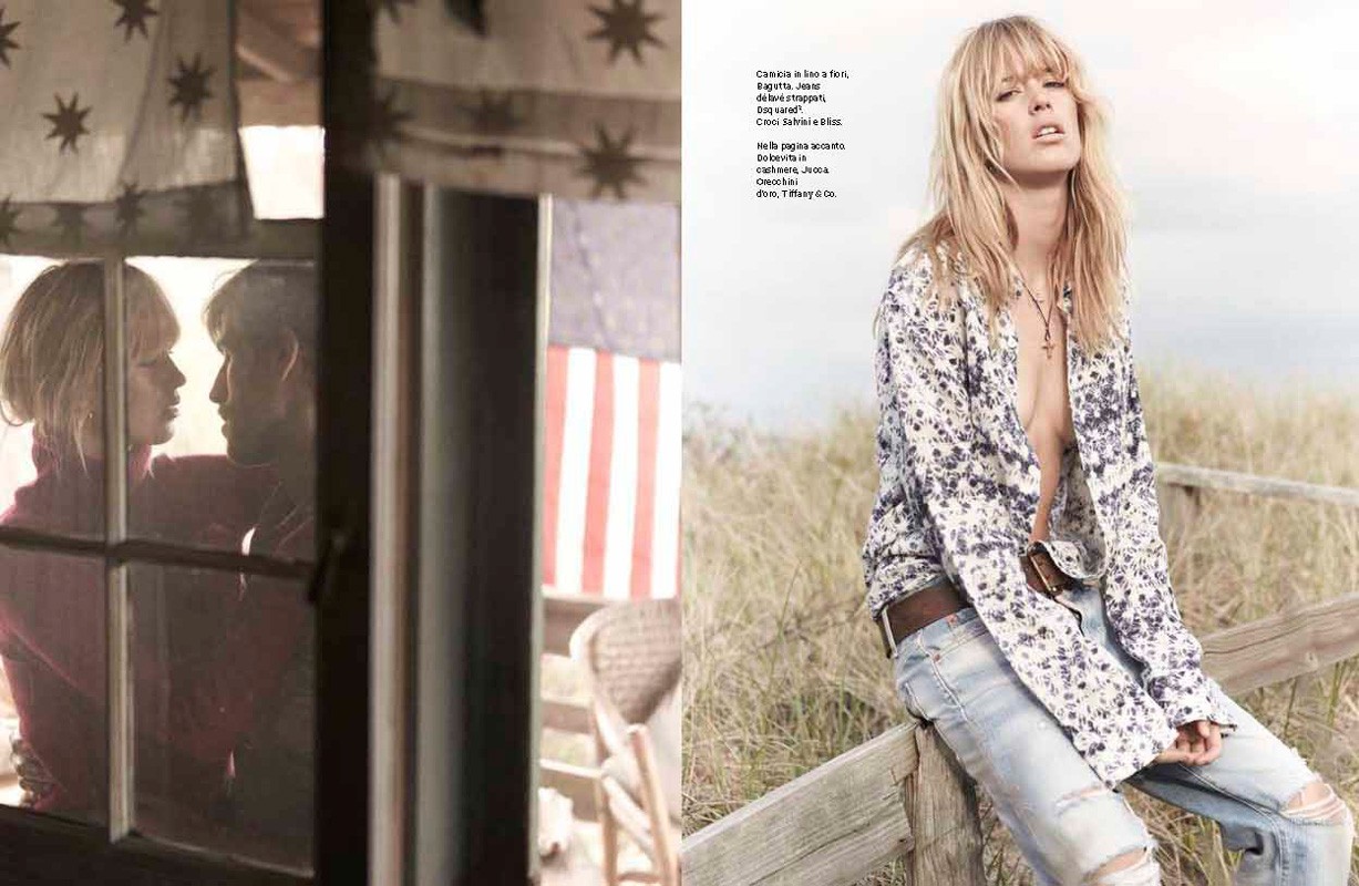 Blonde female model wearing a floral print shirt and distressed jeans seated on a wooden fence outdoors.