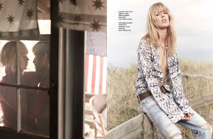Blonde female model wearing a floral print shirt and distressed jeans seated on a wooden fence outdoors.