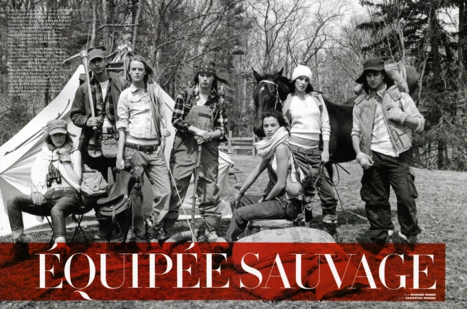 Seven people pose in outdoor fashion editorial with horse, tent, camping gear, and forest backdrop in a black and white photograph.