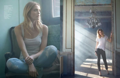 Model with blonde hair sitting in a vintage armchair wearing a white tank top and light blue denim jeans with text overlay.