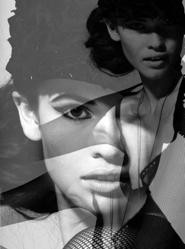 Black and white portrait of a woman with dramatic eye makeup and a net fabric overlay creating a layered, artistic effect.