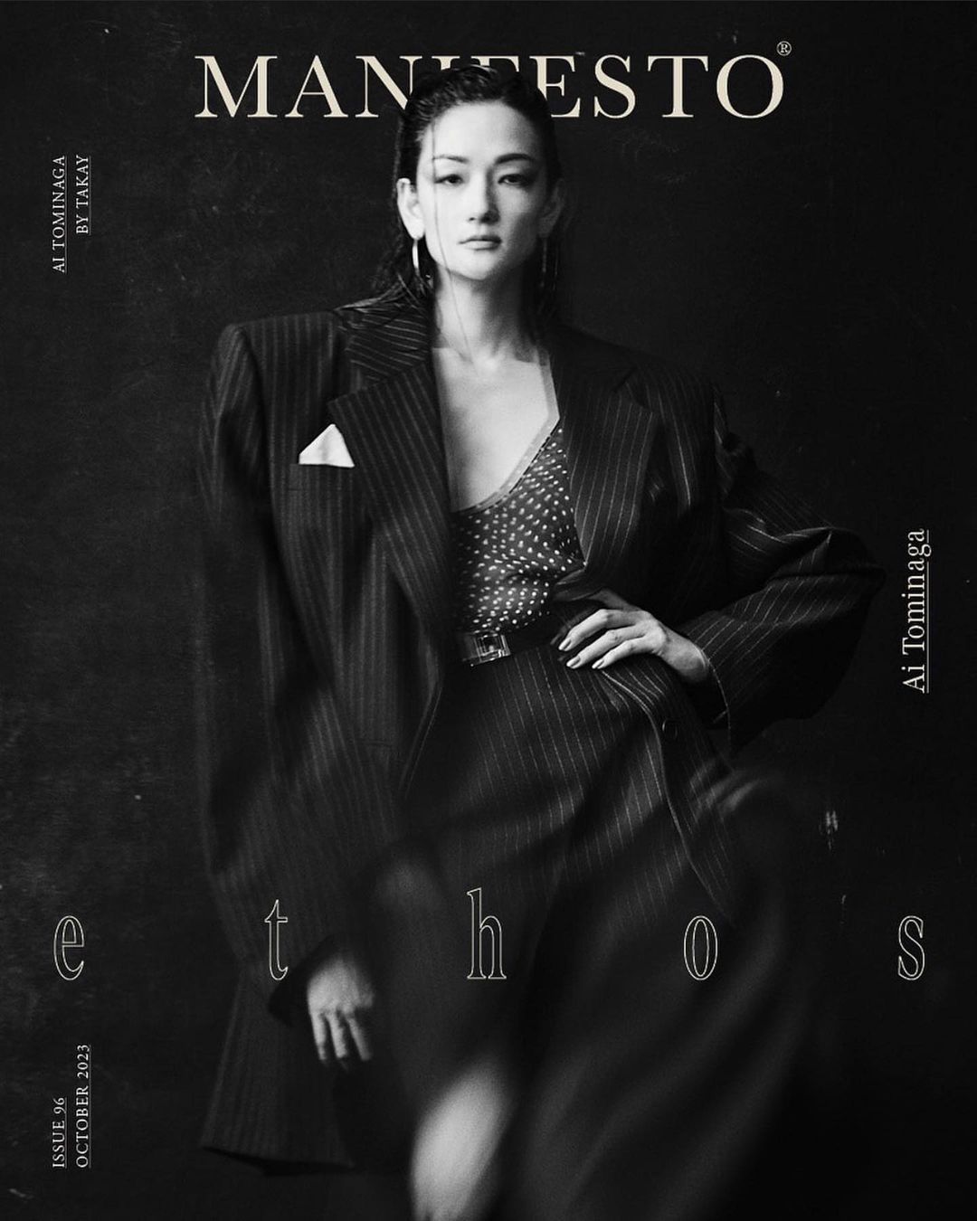 Monochrome fashion portrait of a stylish Asian woman in a pinstripe blazer on a magazine cover with text overlays and black backdrop.