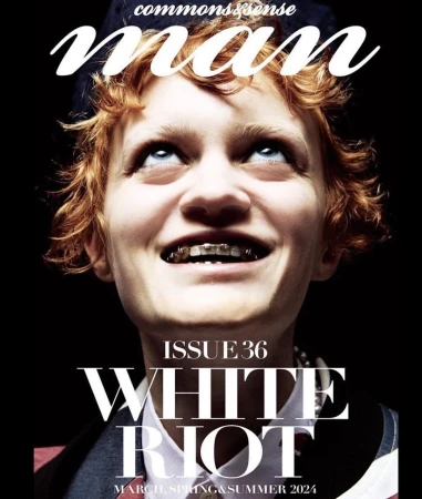 Magazine cover featuring a young adult with red hair looking up, wearing braces, and a collared jacket on a black background.