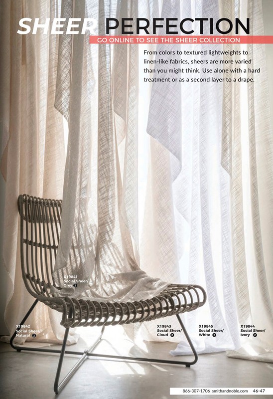 Interior scene featuring a wicker chair in front of sheer curtains, creating a soft, light-filled ambiance, perfect for home decor inspiration.