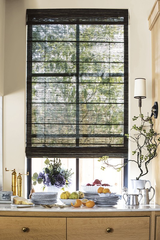 Interior view of a kitchen counter with fruit, flowers and window in the background. Interior design, still life scene.