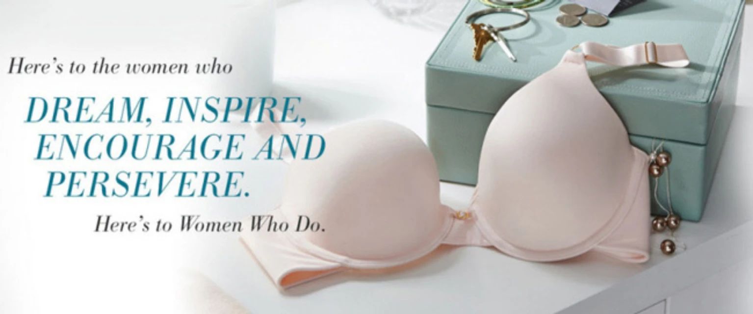 Still life of a light pink bra on a white surface with a light teal jewelry box, keys, and coins in the background. Supportive text overlay.