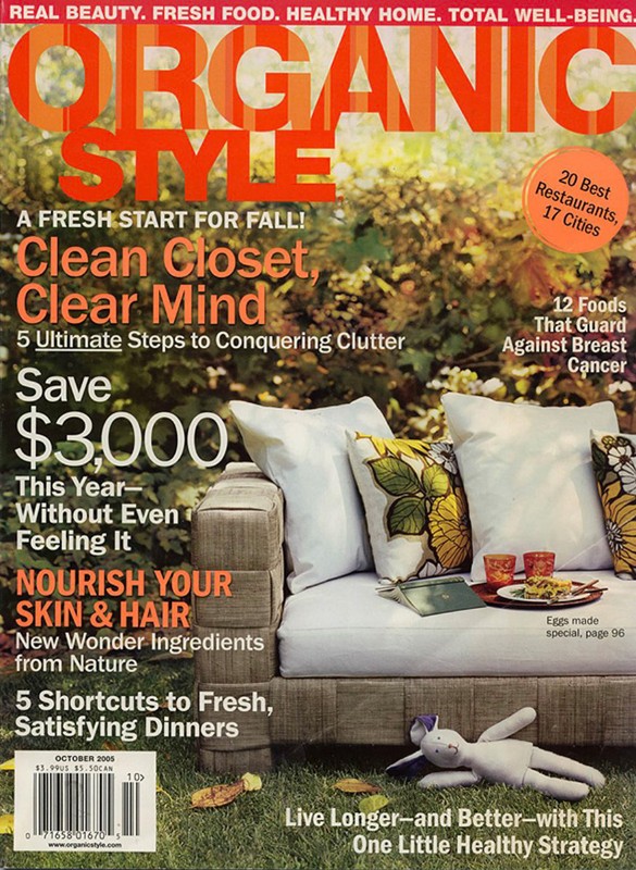 Magazine cover featuring a sofa with white cushions, a tray with food, and text promoting organic style, healthy living, and seasonal content.