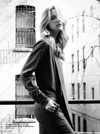 Monochrome fashion portrait of a female model outdoors against a building exterior with barred windows, styled by Tatiana Cinquino.