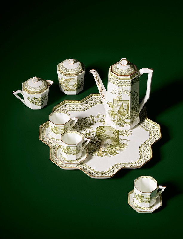 Elegant tea set with teapot, creamer, sugar bowl, cups, saucers, and serving tray featuring detailed green and white pastoral designs.