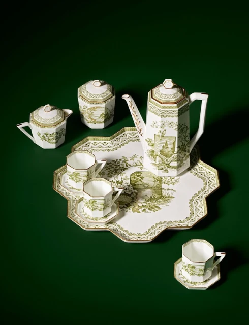 Elegant tea set with teapot, creamer, sugar bowl, cups, saucers, and serving tray featuring detailed green and white pastoral designs.