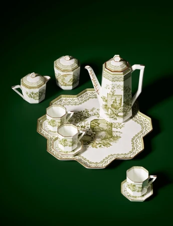 Elegant tea set with teapot, creamer, sugar bowl, cups, saucers, and serving tray featuring detailed green and white pastoral designs.