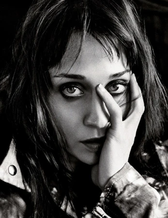 Close up monochrome portrait of a woman with dark hair touching her face