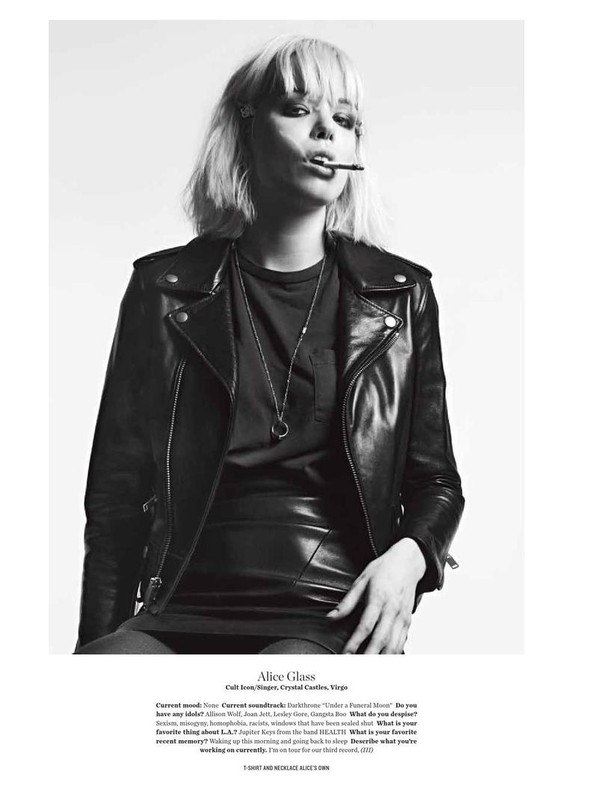Black and white portrait of Alice Glass smoking, wearing a leather jacket and skirt, with short blonde hair and a silver necklace.