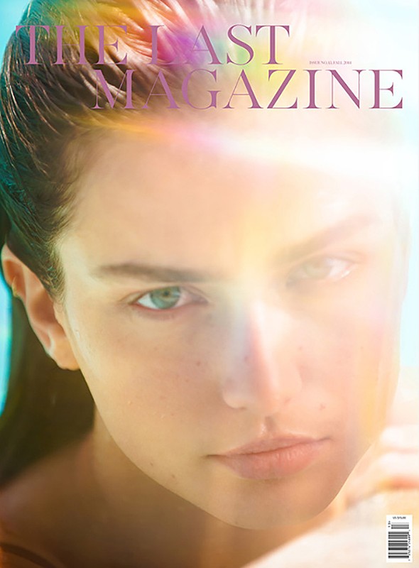 Close-up magazine cover shot of an adult female's face with light rainbow-color effects, soft light, and minimal makeup.