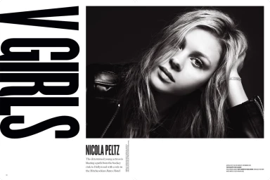 Black and white portrait of Nicola Peltz wearing a leather jacket with hand raised to her head, styled by Tuan Anh Tran.
