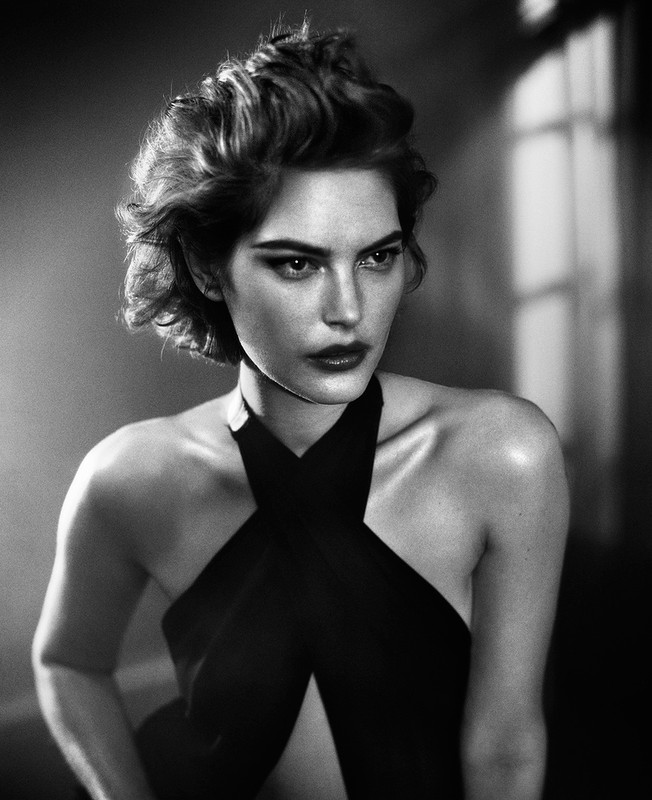 Black and white portrait of a woman in a halter top with short styled hair by photographer Vincent Peters