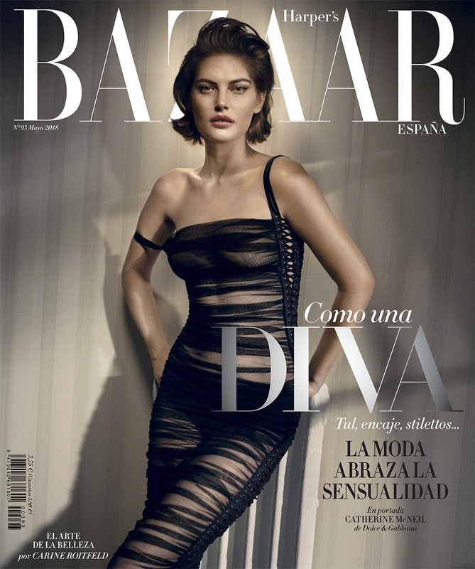 Model Catherine McNeil posing in a sheer black ruched dress for a magazine cover photographed by Vincent Peters.
