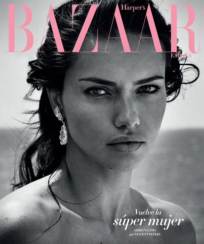 Close-up portrait of a model, Adriana Lima, on the cover of Harper's Bazaar España magazine, with pink and black typography.