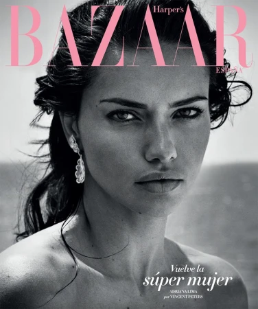 Close-up portrait of a model, Adriana Lima, on the cover of Harper's Bazaar España magazine, with pink and black typography.