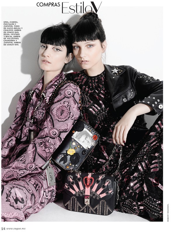 Two women pose indoors in embellished outfits and purses, against a white backdrop in a fashion editorial, high-fashion style.