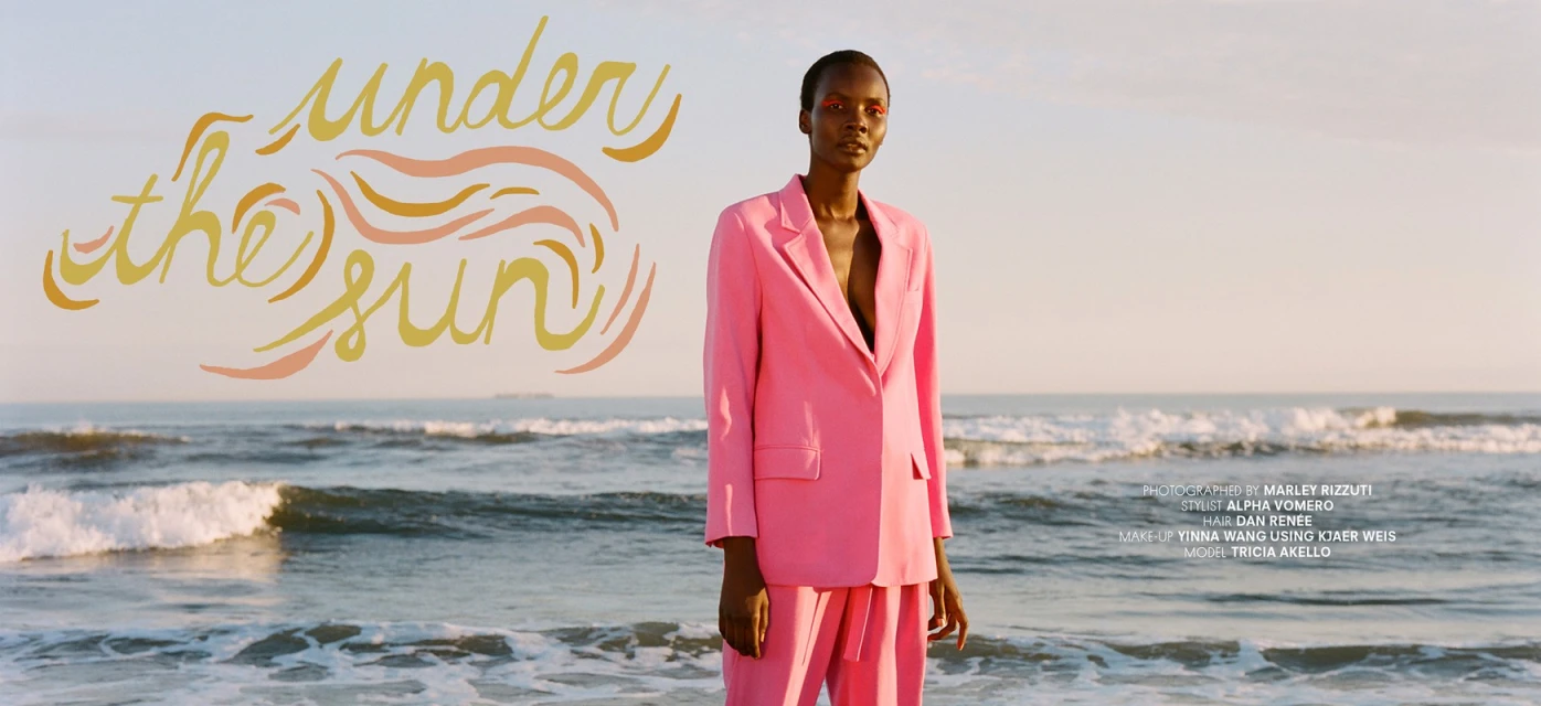 A Black female model in a pink suit stands on a beach with golden hour light, ocean waves, and hand-lettered text in the background.