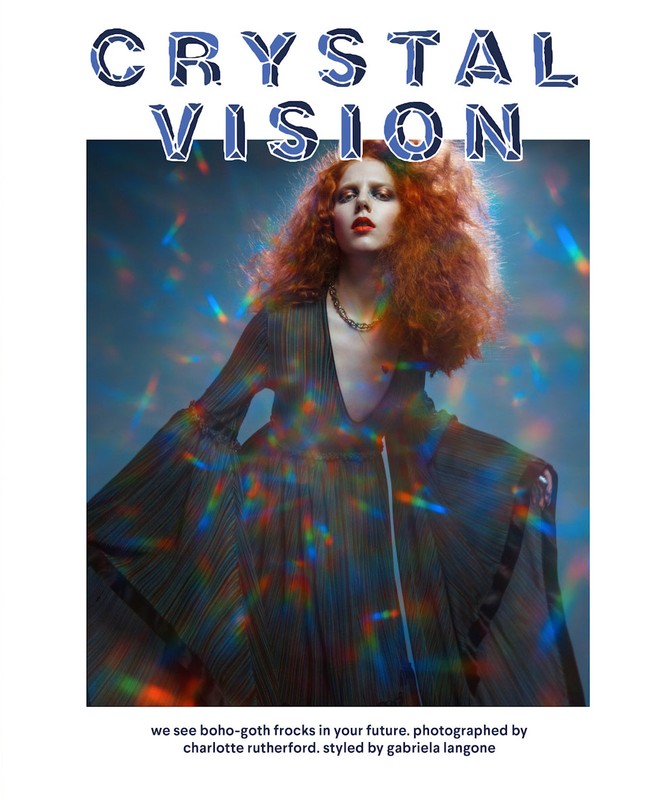 Fashion editorial shot of a red-haired adult woman in a long, dark dress with prism-like color flares. Studio setting with title text overlay.