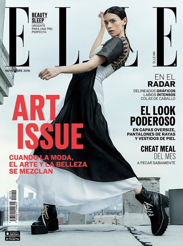 Elle magazine cover featuring a woman in a black and white dress and boots posing on a rooftop in front of a cityscape.