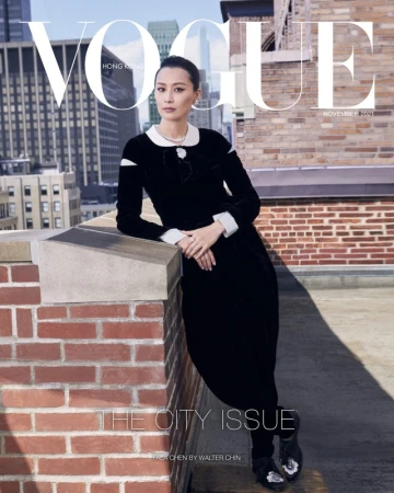 Vogue Hong Kong cover featuring Asian woman in black dress on rooftop with cityscape backdrop. Fashion editorial, city style.