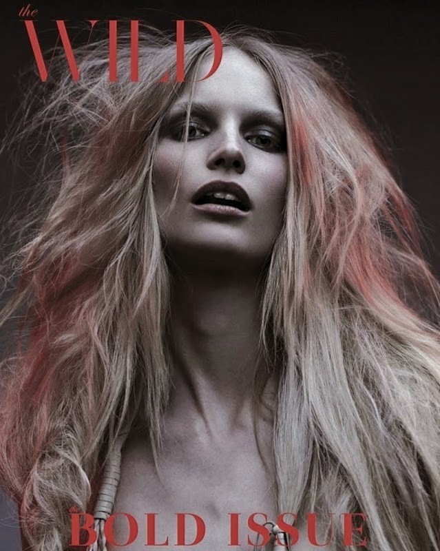 Magazine cover featuring a woman with long, blonde hair and a bold expression, set against a dark background with red text overlay.