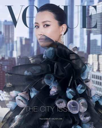 Vogue Hong Kong cover with a woman wearing a layered dress with circular embellishments and diamond earrings, against an urban backdrop.