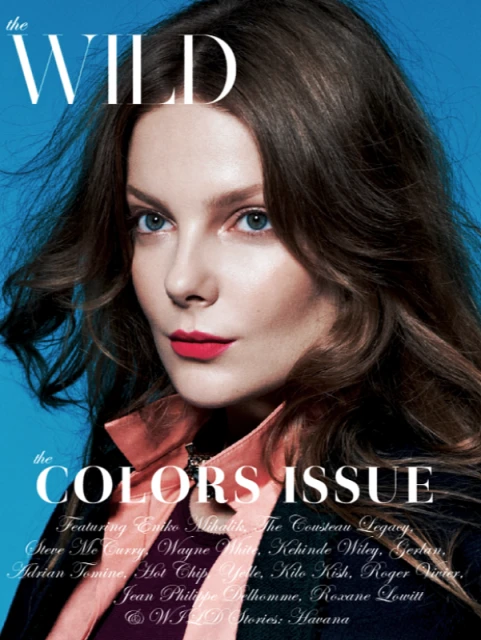 Magazine cover featuring a woman with brown hair and red lipstick against a blue background, promoting 'The Colors Issue' of 'The Wild'.