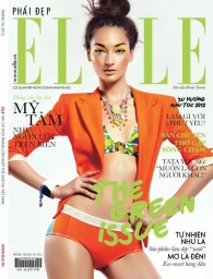Magazine cover featuring a model wearing an orange blazer and matching bikini bottoms with a statement necklace.
