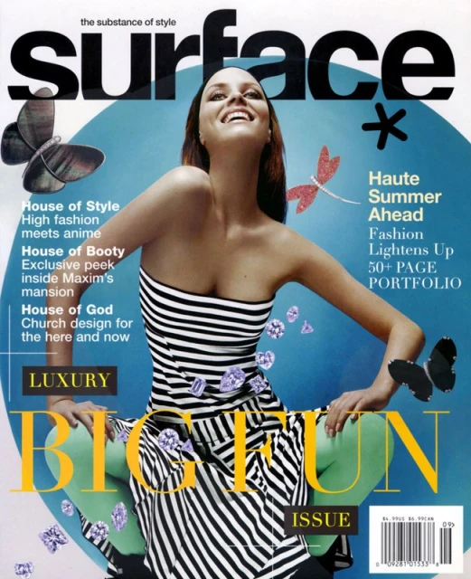 Magazine cover featuring a smiling woman in a striped dress, light-green tights, and scattered purple gems. Bold title 'Surface' is visible.