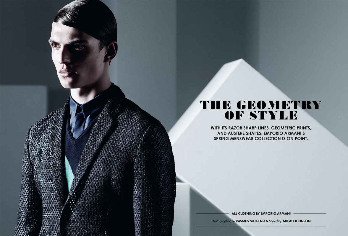 Fashion editorial shot of a young adult male model in a textured blazer and button-down shirt, geometric shapes in background.