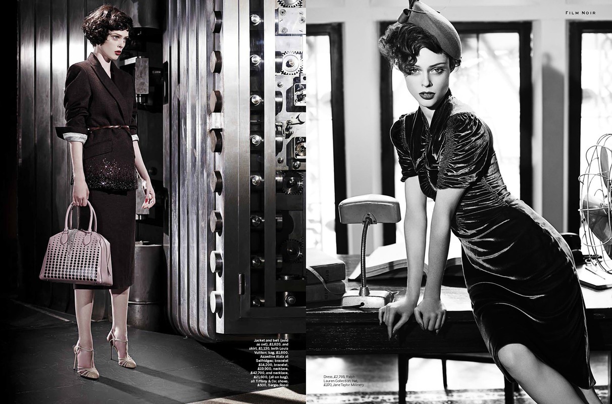 Film noir fashion shoot featuring a model in a velvet dress in black and white, posed against a vintage office setting with a fan.