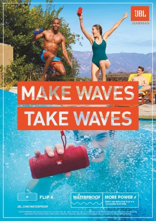 An outdoor ad for JBL with three people by a pool, one underwater with a red Flip 4 waterproof portable speaker, promoting sound and music.