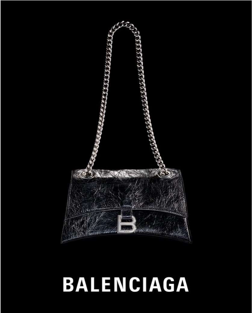 Silver chain-strap handbag with silver hardware and logo against black backdrop; fashion accessory with luxury branding.