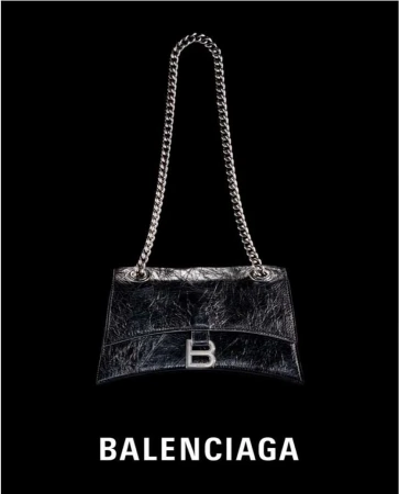 Silver chain-strap handbag with silver hardware and logo against black backdrop; fashion accessory with luxury branding.