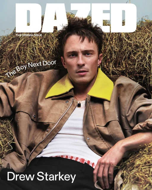 Dazed magazine cover featuring Drew Starkey in a tan jacket, white t-shirt, and black pants while sitting on hay.