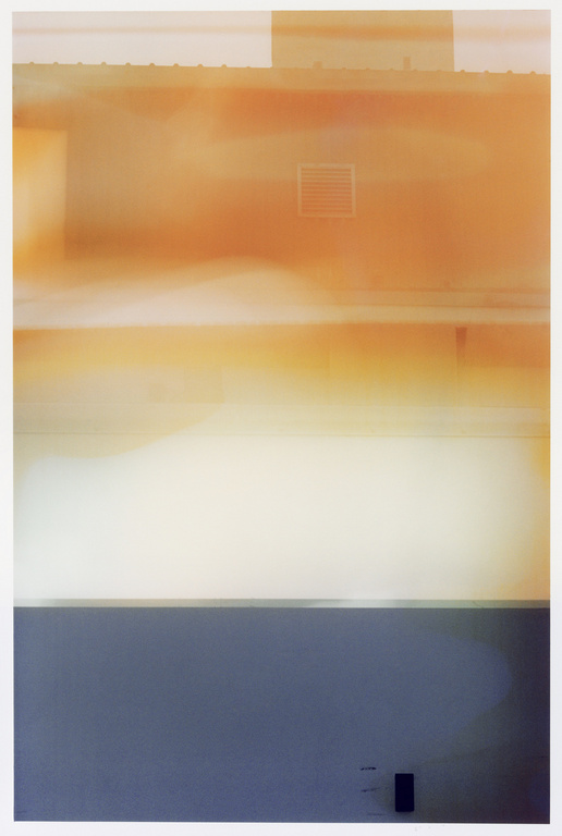 Abstract photography of a building facade featuring muted orange tones with a gray base, creating a serene and modern aesthetic.