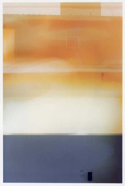 Abstract photography of a building facade featuring muted orange tones with a gray base, creating a serene and modern aesthetic.